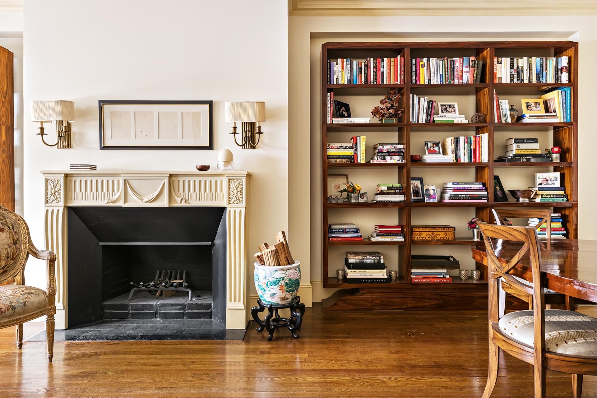 925 Park Avenue, Unit 2A Manhattan, NY 10075 - Photo 10 of 18 a living room with lots of books and a wooden floor