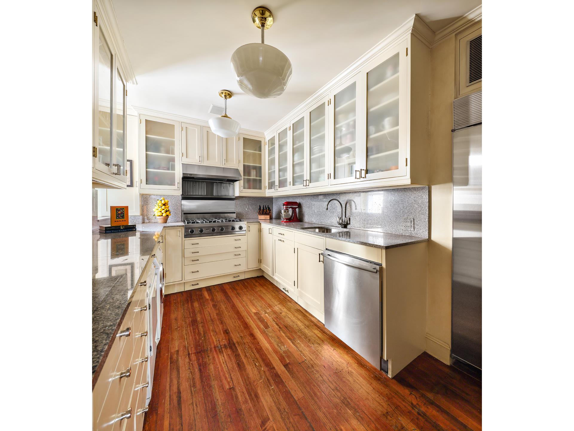 925 Park Avenue, Unit 2A Manhattan, NY 10075 - Photo 15 of 18 a kitchen with stainless steel appliances granite countertop a stove and a sink
