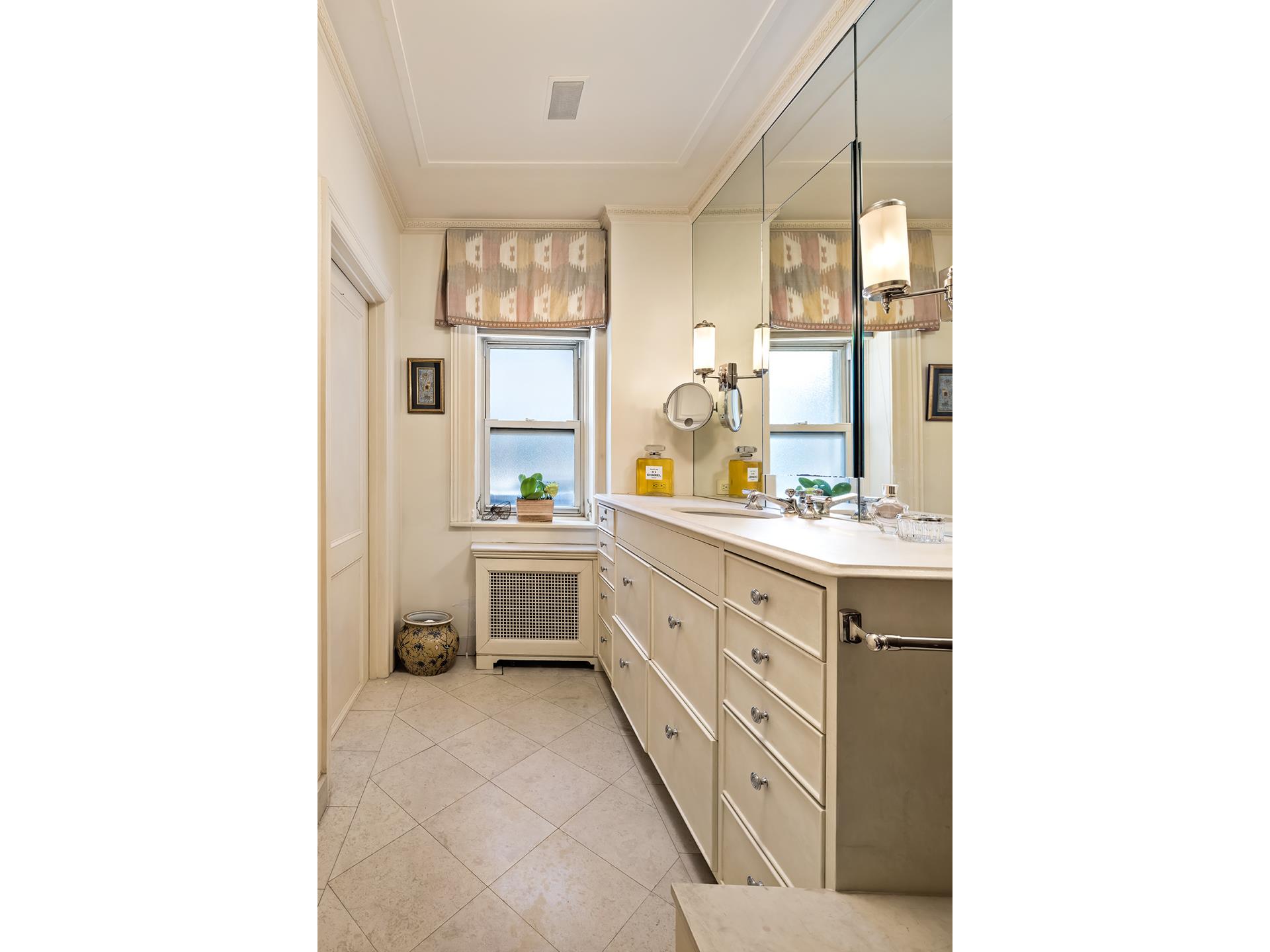925 Park Avenue, Unit 2A Manhattan, NY 10075 - Photo 16 of 18 a bathroom with a sink double vanity and a mirror