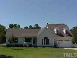 9325 Farm Meadow Road Raleigh, NC 27603 - Photo 1 of 1 front view of a house with a garden