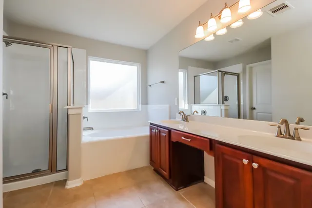 a bathroom with a tub sink and mirror