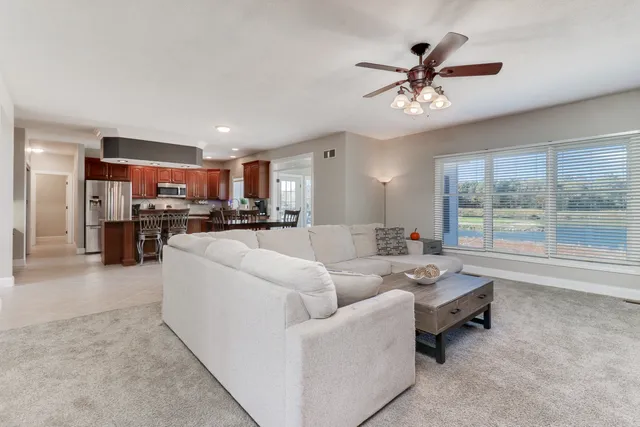 a view of a kitchen with a refrigerator and a stove top oven