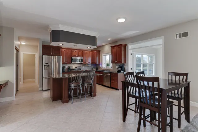 a kitchen with stainless steel appliances granite countertop a sink stove and microwave
