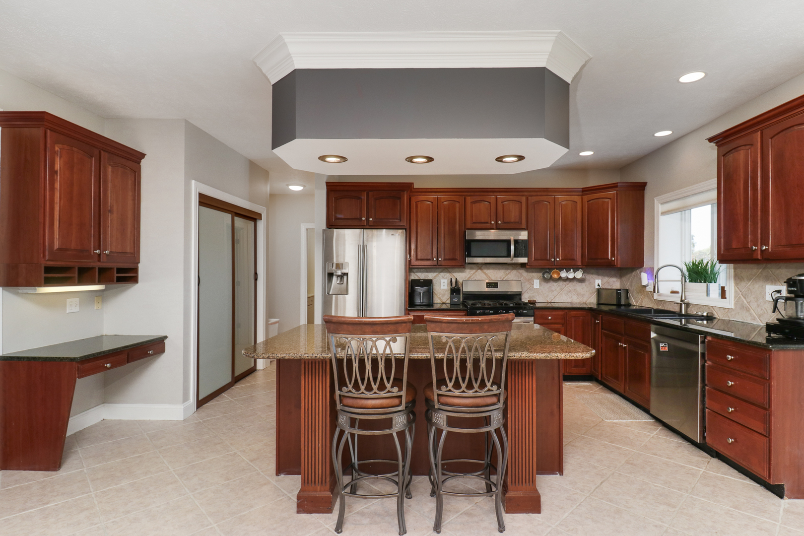 3 Pebblebrook Court Bloomington, IL 61705 - Photo 13 of 89 a kitchen with stainless steel appliances a table and chairs in it