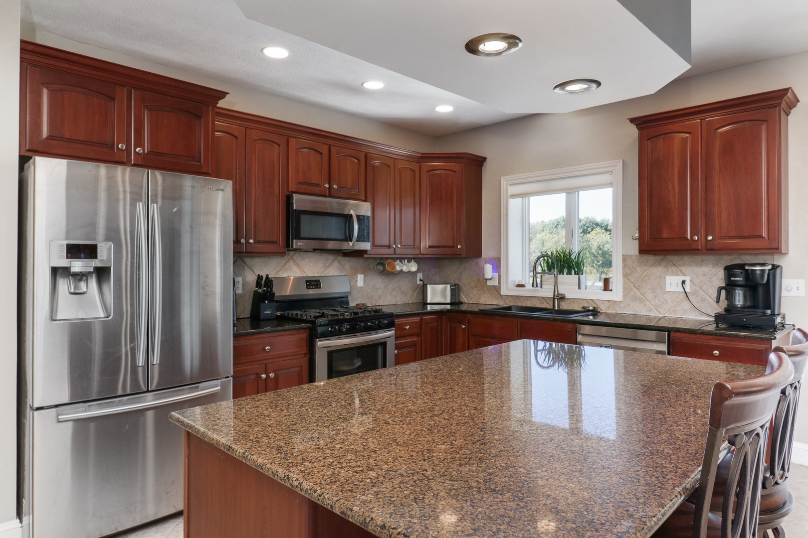 3 Pebblebrook Court Bloomington, IL 61705 - Photo 14 of 89 a kitchen with granite countertop a refrigerator stove top oven a sink and dishwasher