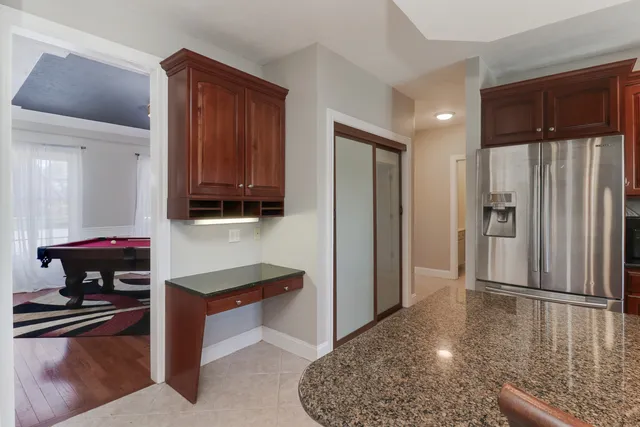 a large bed sitting in a bedroom next to a window