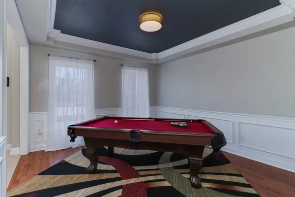 a living room with furniture and a ceiling fan