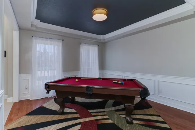 a living room with furniture and a ceiling fan