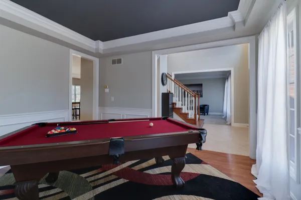 a living room with furniture and a chandelier