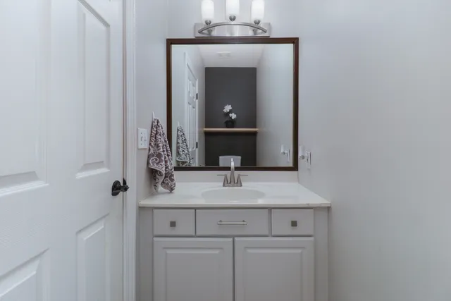 a view of a livingroom with furniture and a bookshelf