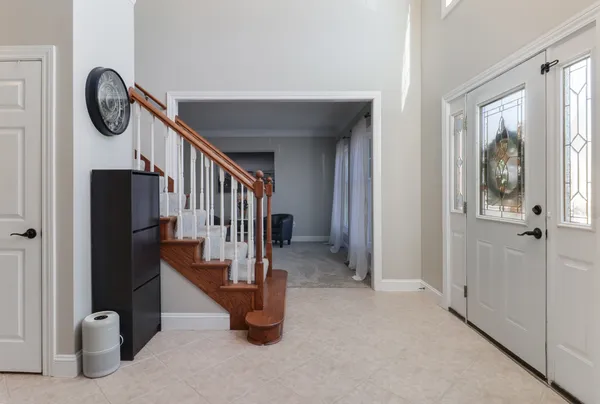 a kitchen with stainless steel appliances refrigerator dining table and chairs