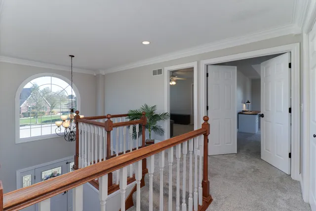 a living room with furniture a flat screen tv and potted plant