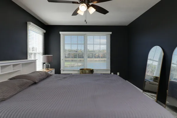 a kitchen with white cabinets a sink dishwasher and a stove with wooden floor
