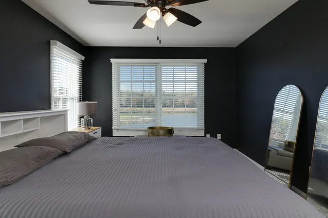 a kitchen with white cabinets a sink dishwasher and a stove with wooden floor