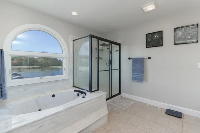 a large kitchen with stainless steel appliances granite countertop a lot of counter space and wooden floors