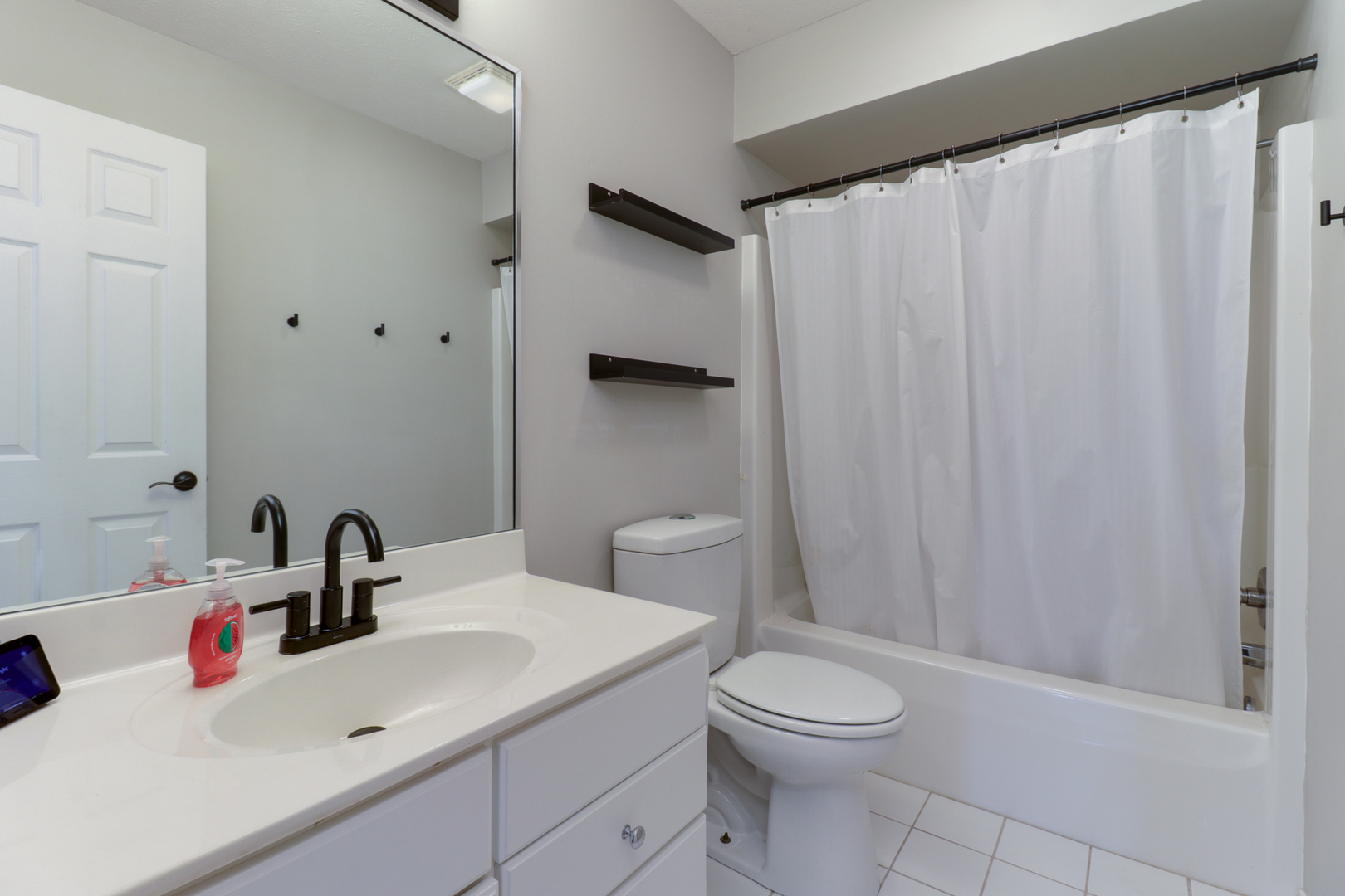 3 Pebblebrook Court Bloomington, IL 61705 - Photo 41 of 89 a bathroom with a sink a toilet and shower curtain