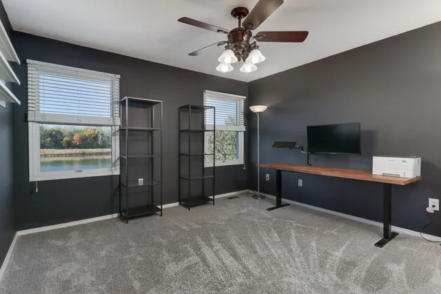 a view of a house with swimming pool and a yard