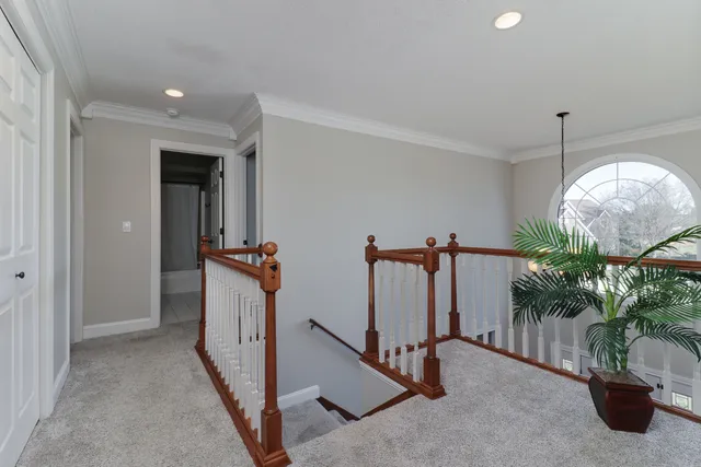 a aerial view of a house with a yard and a lake view