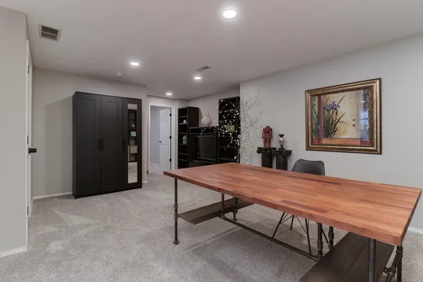 an aerial view of a golf course with a lake view