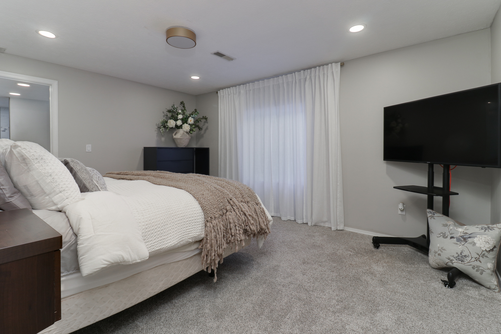 3 Pebblebrook Court Bloomington, IL 61705 - Photo 60 of 89 a spacious bedroom with a bed and a flat screen tv