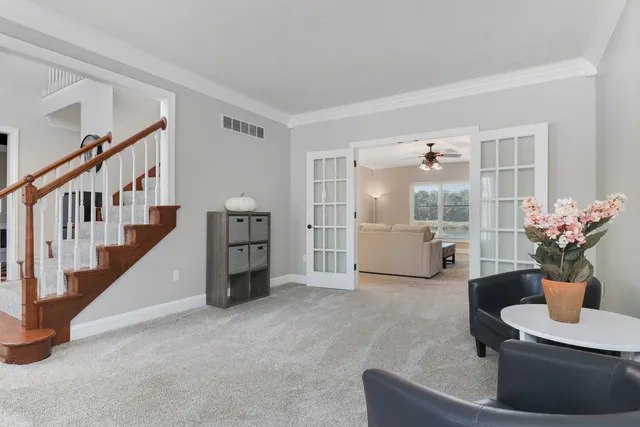 a living room with furniture and kitchen view