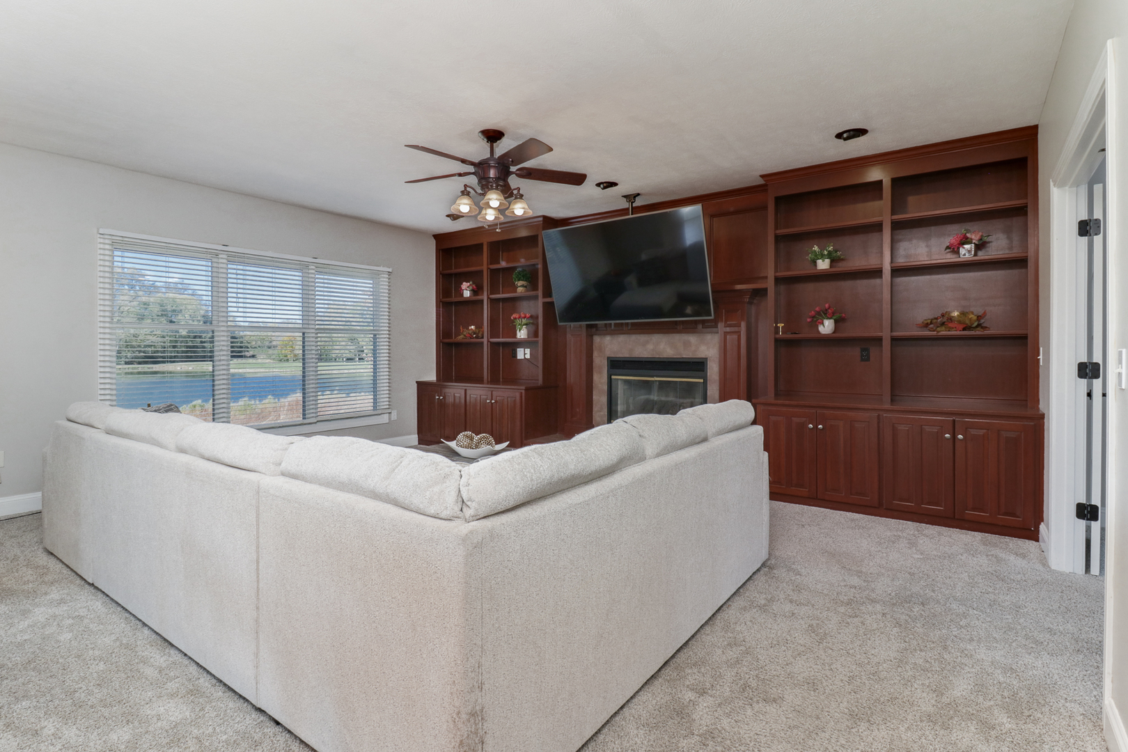 3 Pebblebrook Court Bloomington, IL 61705 - Photo 8 of 89 a living room with furniture a flat screen tv and a fireplace
