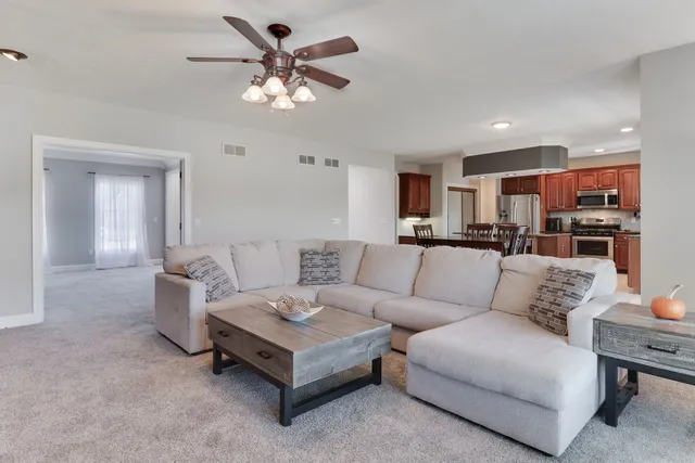 a kitchen with stainless steel appliances granite countertop a sink stove microwave and refrigerator