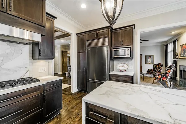 a kitchen with stainless steel appliances granite countertop a stove and a refrigerator