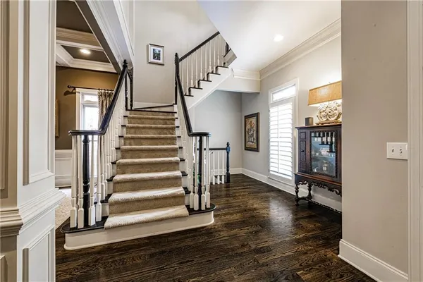 a view of entryway and hall with wooden floor
