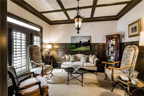 a living room with furniture a rug and white walls