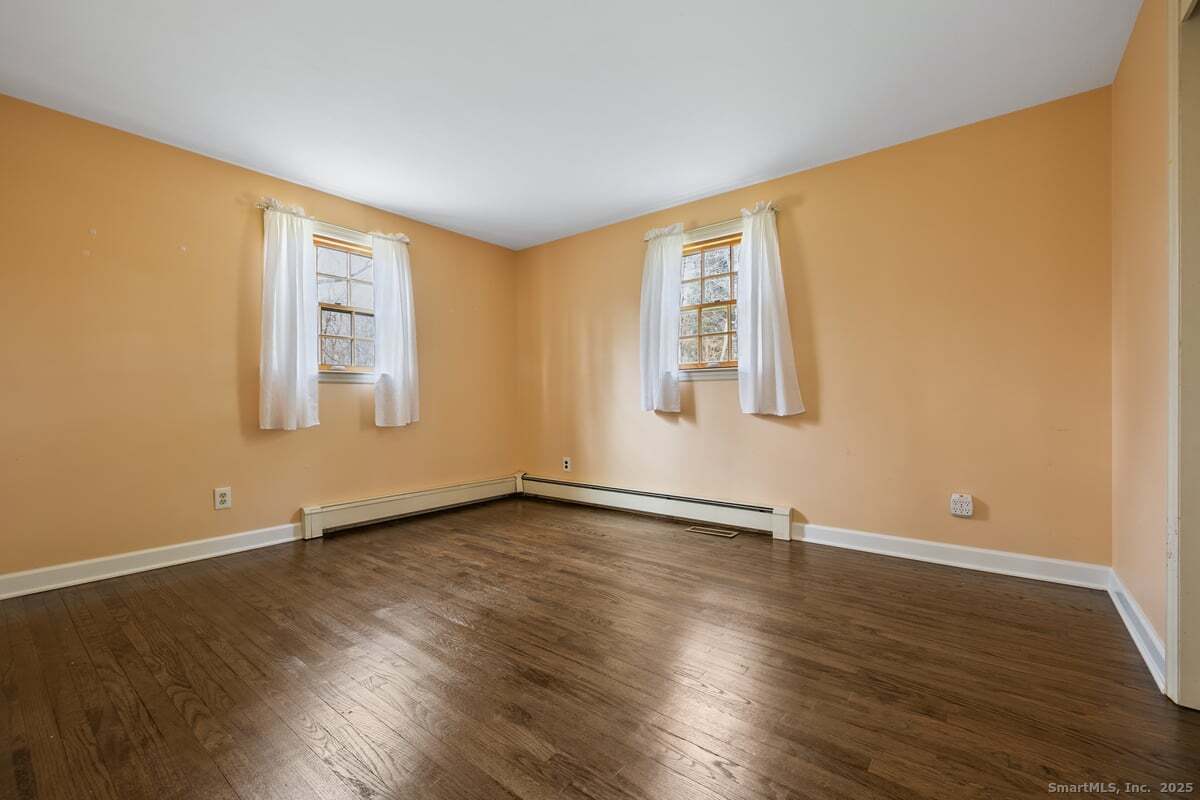 95 Ridgewood Road Ridgefield, CT 06877 - Photo 13 of 31 a view of an empty room with wooden floor and a window