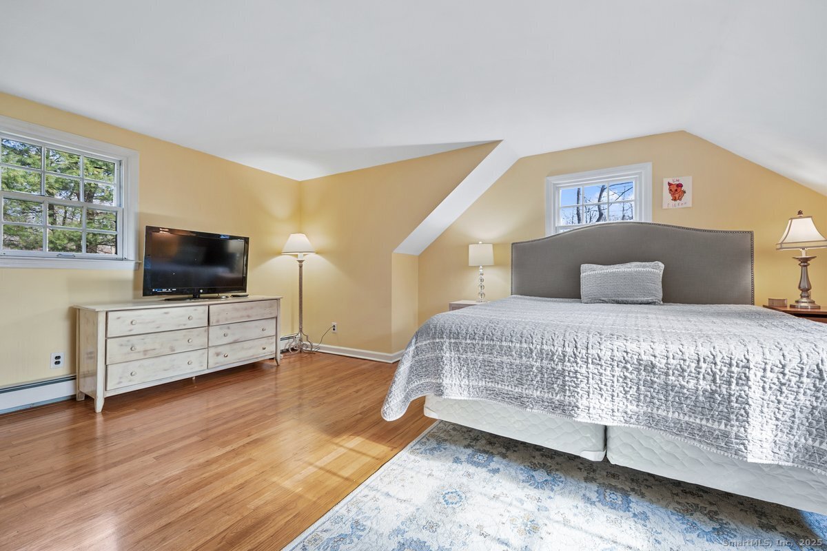 95 Ridgewood Road Ridgefield, CT 06877 - Photo 17 of 31 a bedroom with a bed and flat screen tv