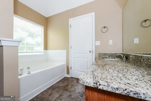 a bathroom with a bathtub and a sink