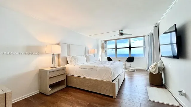 a bedroom with a bed and a large window