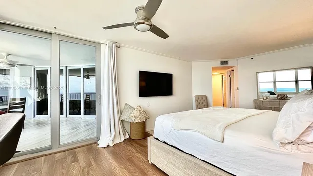 a bedroom with a bed and a large window