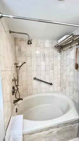 a bathroom with a bathtub and shower