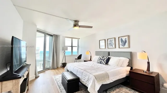 a bedroom with a bed and a flat screen tv