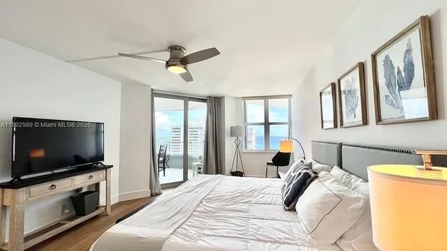 a bedroom with a bed and a flat screen tv