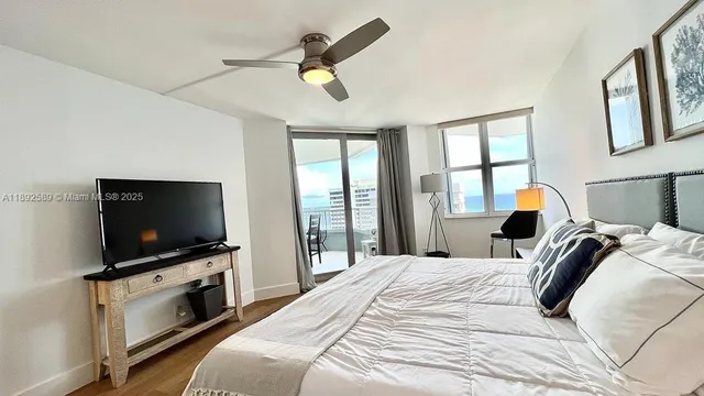 a bedroom with a bed and a flat screen tv