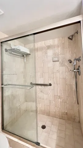 a bathroom with a glass shower door