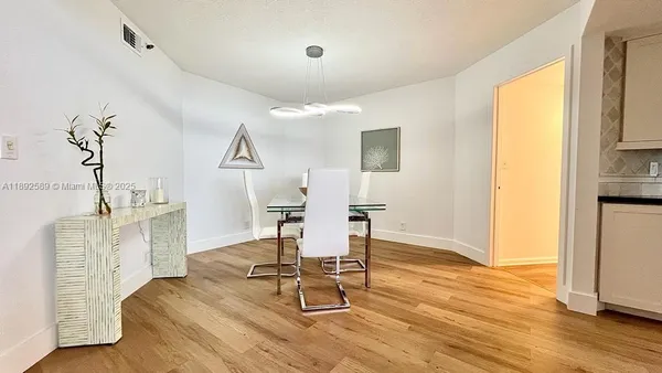 a workspace room with furniture and wooden floor