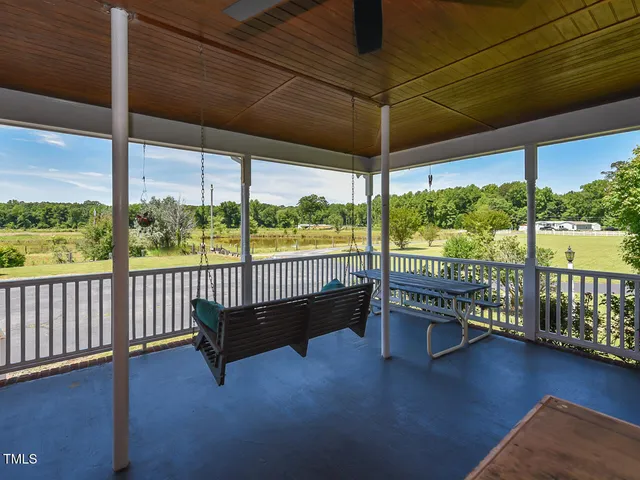 a balcony with furniture and garden view