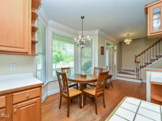 a dining room with furniture a chandelier and wooden floor
