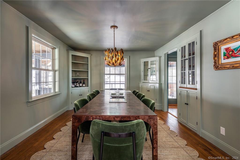 63 Cemetery Hill Road Cornwall, CT 06796 - Photo 12 of 45 a dining room with wooden floor a chandelier a wooden table and chairs