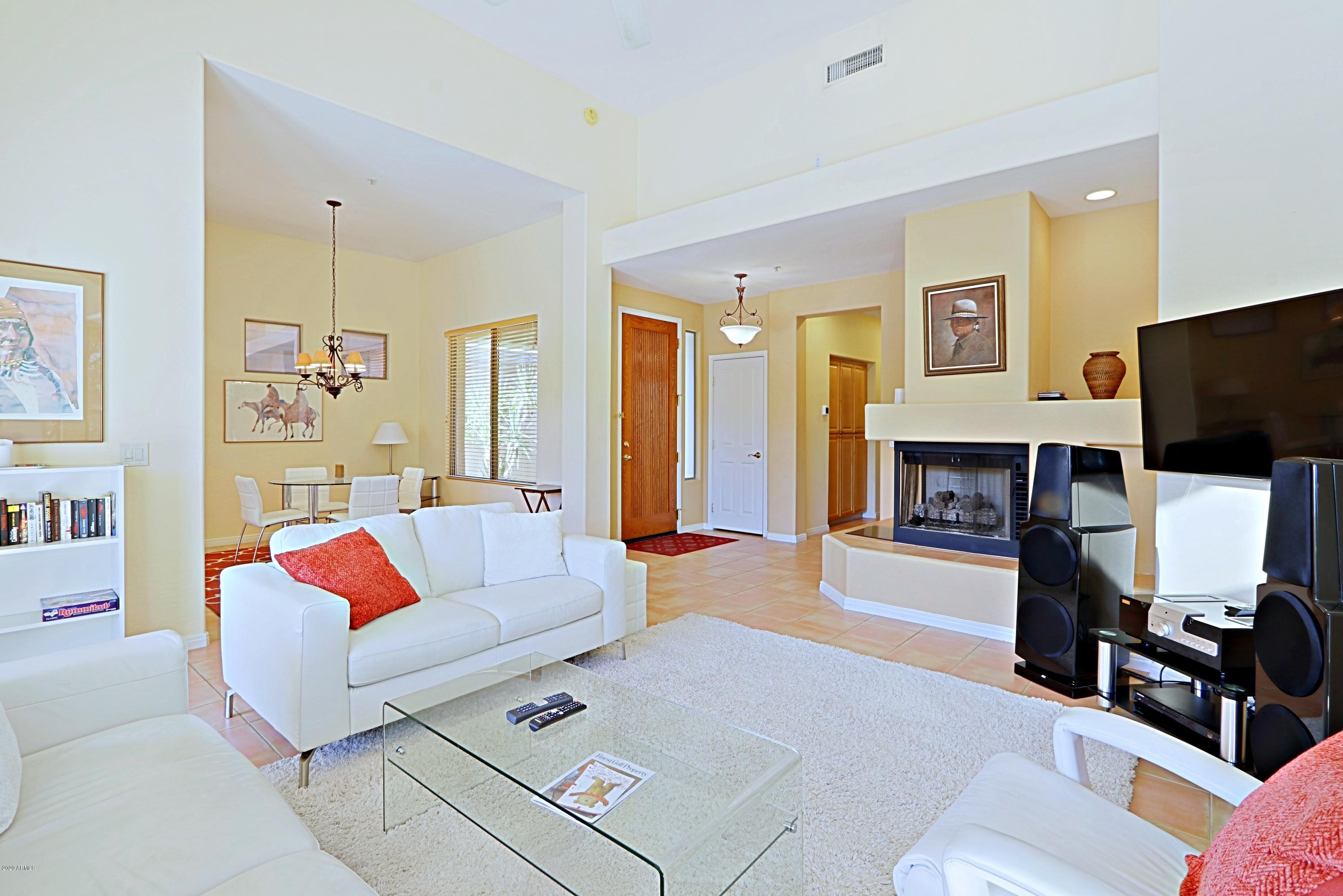 6803 East Eagle Feather Road Scottsdale, AZ 85266 - Photo 3 of 67 a living room with furniture and a flat screen tv