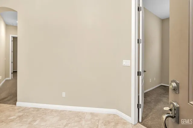 a view of an empty room with windows and a fireplace