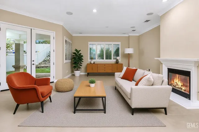 a view of an empty room with a fireplace and a window
