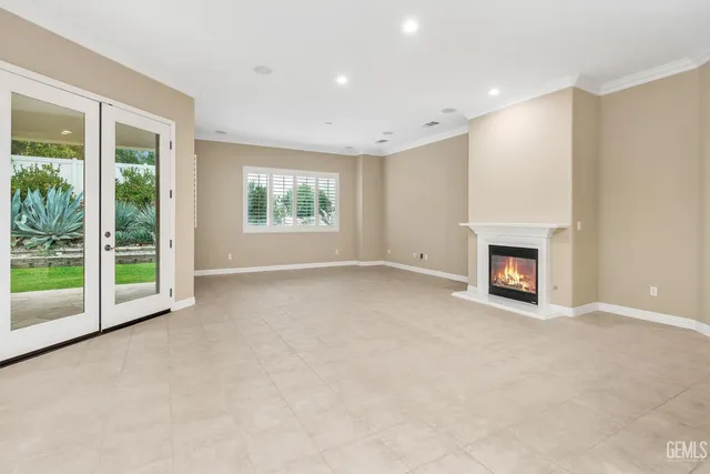 a kitchen with stainless steel appliances granite countertop a stove a sink dishwasher a refrigerator with a dining table and chairs