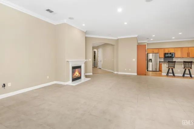 a kitchen with stainless steel appliances granite countertop a refrigerator a stove and a wooden floors