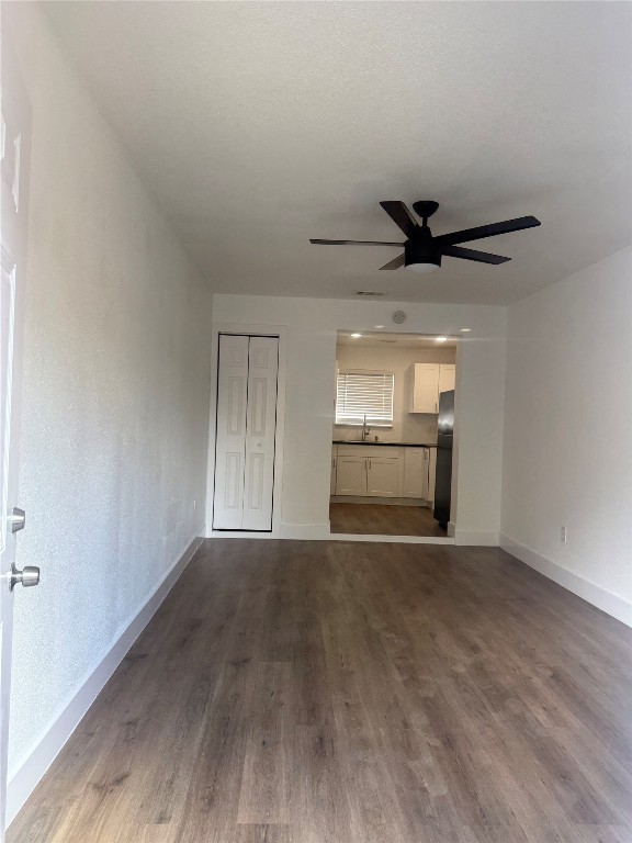 9205 Georgian Drive, Unit A2 Austin, TX 78753 - Photo 5 of 8 a view of an empty room and a kitchen with wooden floor
